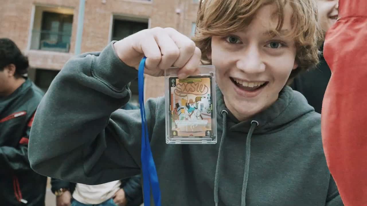 Attendee holding a Pudgy Penguins SXSW trading card