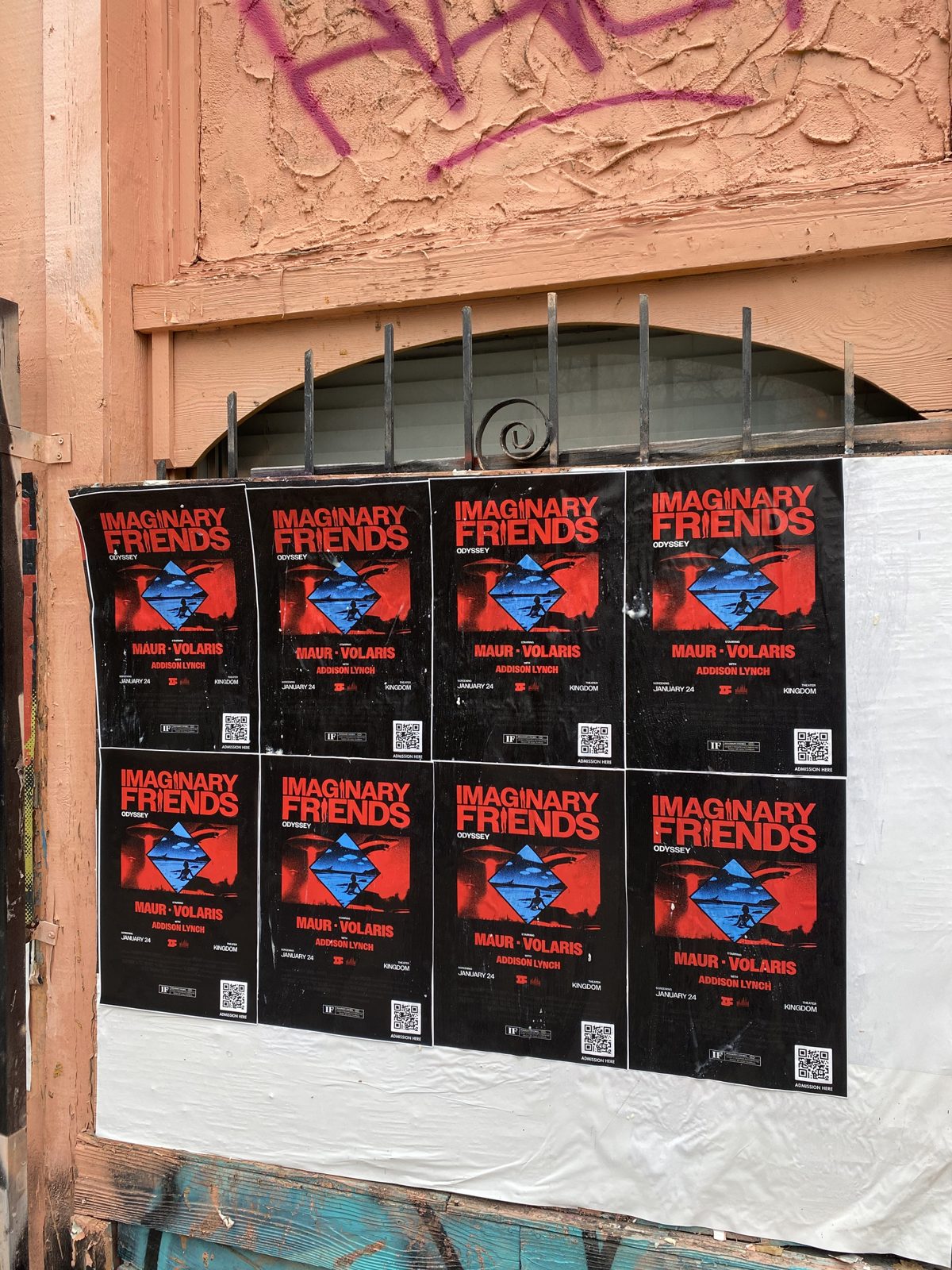 Wheat-pasted posters covering a city wall